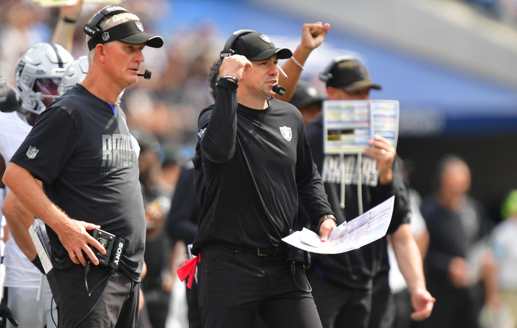 Las Vegas Raiders coaches on the sideline during a game against the Los Angeles Chargers.