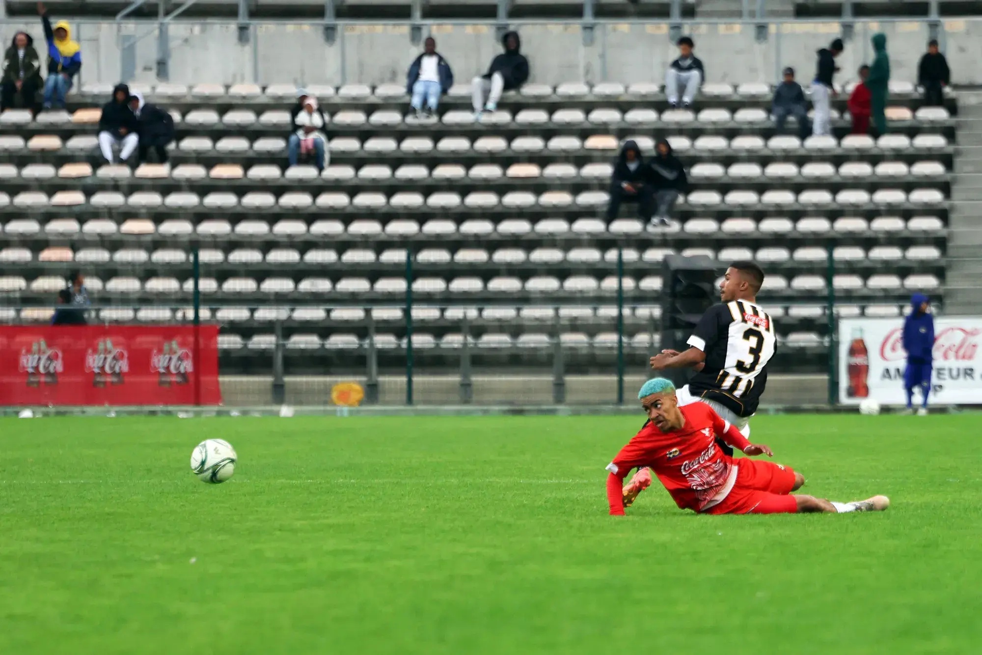 Hanover Park’s Imtiyaaz Ruiters and Saxon Rovers’ Ridhaa Essack challenge for a loose ball during their Coke Cup final at Athlone Stadium on Saturday.