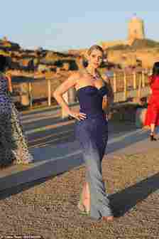 Kitty Spencer was pictured posing with her hands on her hips wearing an embellished blue strapless gown as she stood in the sunshine