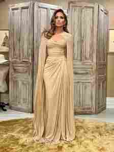 Jennifer Lopez wears a beige gown and cape look on her Instagram