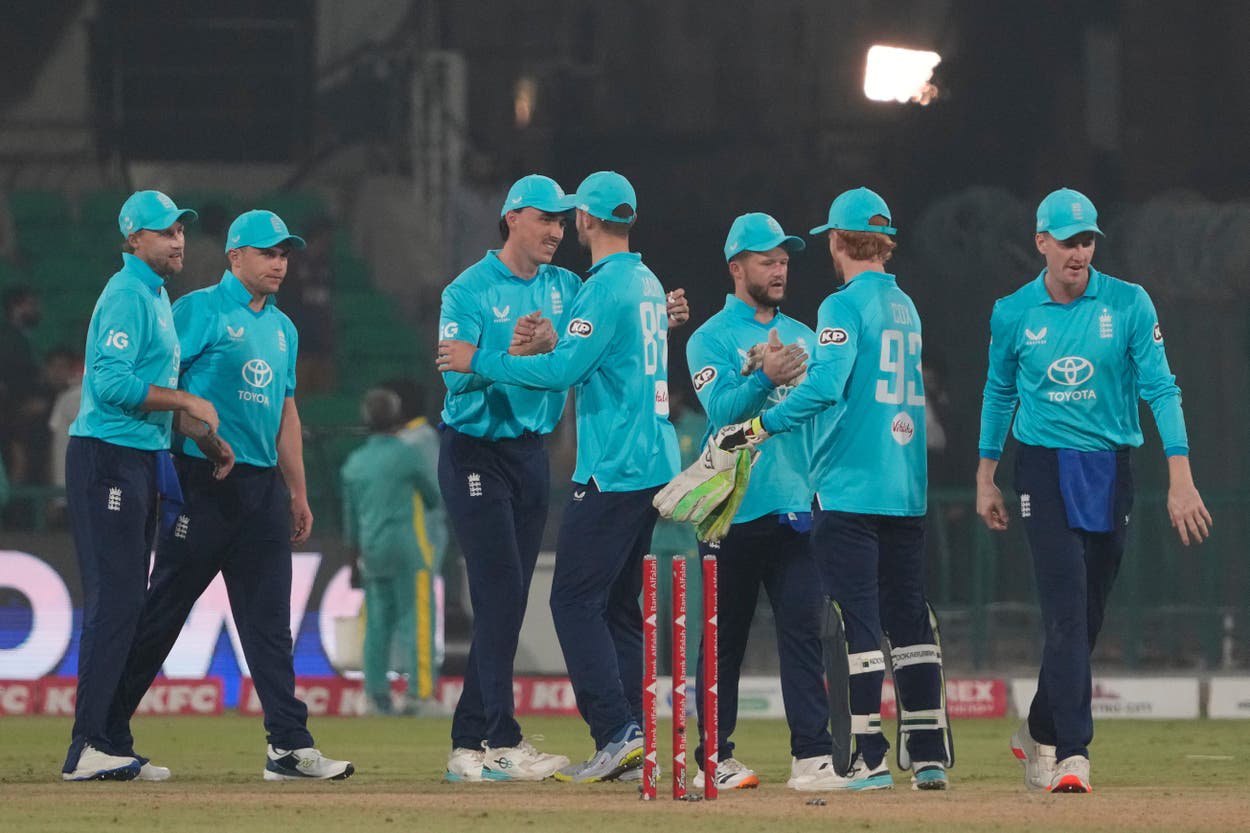 England’s players celebrate the win in Lahore (KM Chaudary/AP)