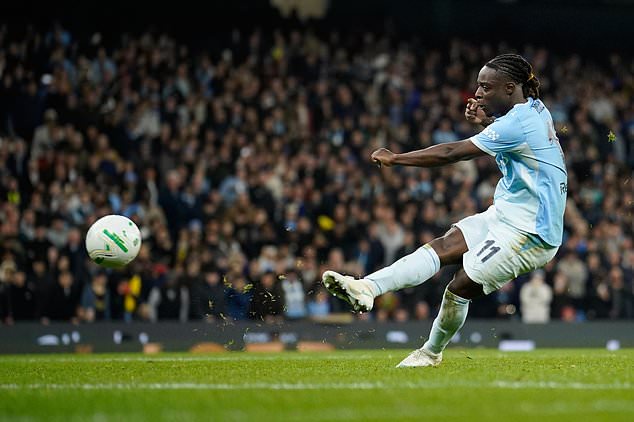 Manchester City's Jeremy Doku scores from a penalty kick during penalty shootout during the English League Cup soccer match between Manchester City and Brighton and Hove Albion in Manchester, England, Wednesday, Oct. 28, 2026. (AP Photo/Dave Thompson)