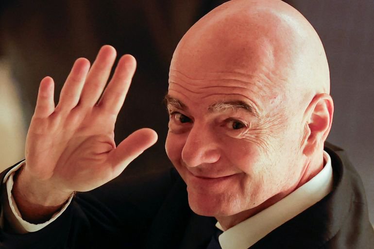FIFA president Gianni Infantino waves to reporters as he leaves from a venue for the Asian Football Confederation (AFC)'s extraordinary congress in Tokyo