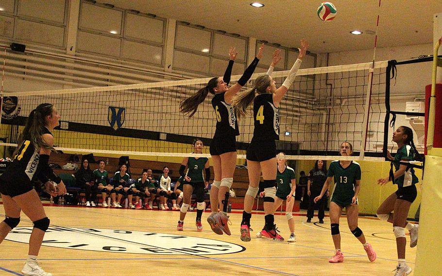 Junior setter/middle blocker Isabell Green, left, and sophomore opposite hitter/middle blocker Alessandra Macy of the Vicenza girls’ volleyball team attempt to block the ball during a semifinal game against Naples in the 2026 DODEA-Europe volleyball championships Division II tournament at the Ederle Fitness Center gym on Caserma Ederle in Vicenza, Italy, on Friday, Oct. 30, 2026. 