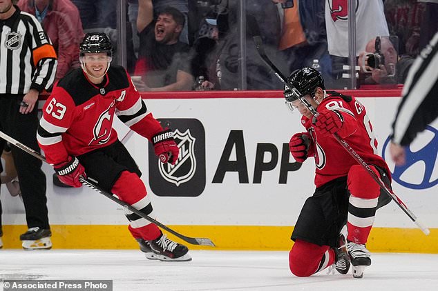 New Jersey Devils' Arseny Gritsyuk, right, celebrates his goal during the third period of an NHL hockey game against the Colorado Avalanche in Newark, N.J., Tuesday, Oct. 20, 2026. (AP Photo/Seth Wenig)