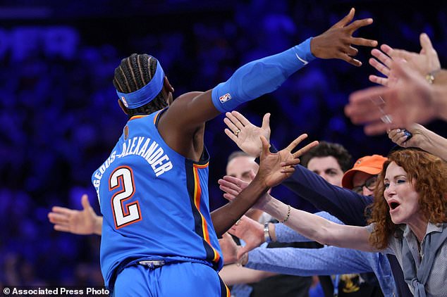 Oklahoma City Thunder guard Shai Gilgeous-Alexander celebrates with fans after making a basket during the second half of an NBA basketball game against the Denver Nuggets, Thursday, Oct. 22, 2026, in Oklahoma City. (AP Photo/Nate Billings)