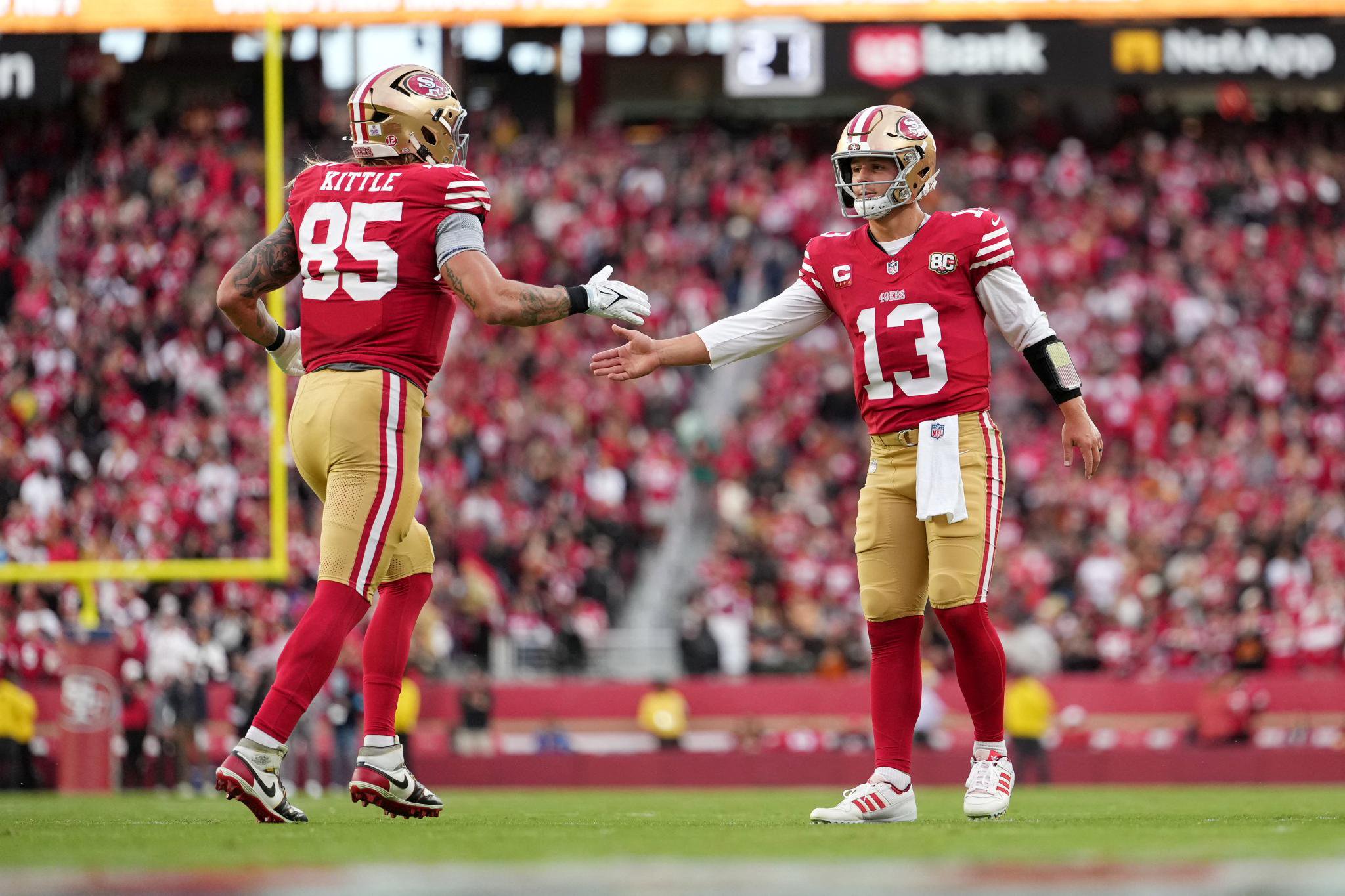 San Francisco 49ers quarterback Brock Purdy (13) celebrates a touchdown with tight end George Kittle (85).