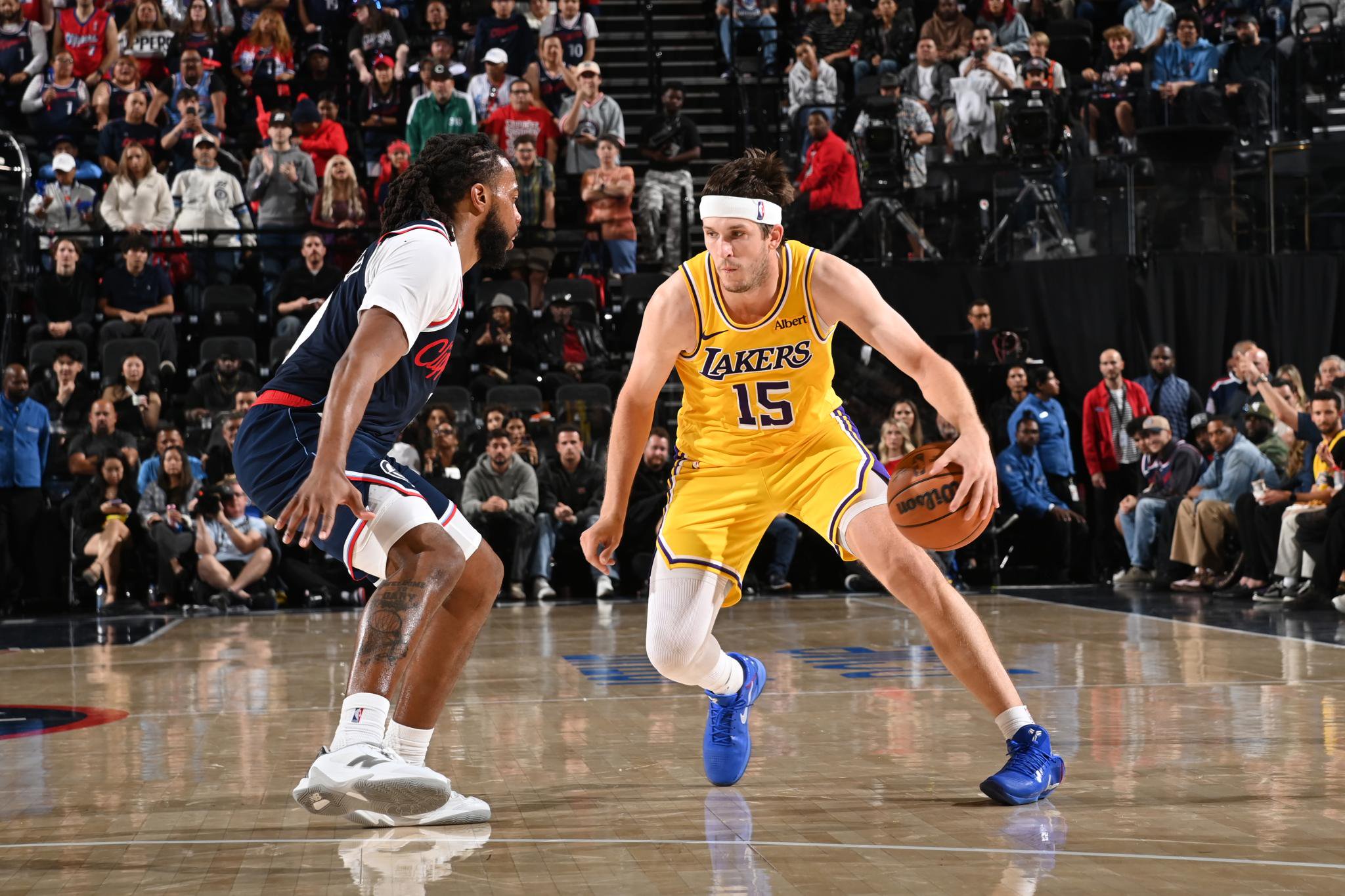 Austin Reaves of the Los Angeles Lakers handles the ball against an LA Clippers defender during a game at the Intuit Dome.