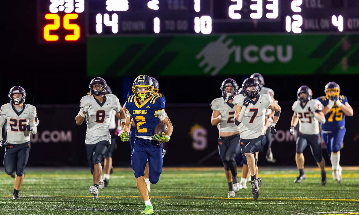 Southridge's Tayton Jackman (2) races downfield on an 88-yard touchdown run as Kennewick defenders pursue him in the fourth quarter Thursday at Neil F. Lampson Stadium in Kennewick. The touchdown followed a Kennewick fumble recovered by the Suns and helped secure Southridge's first Mid-Columbia Conference football championship since 2008