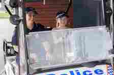 Officer and young girl driving vehicle