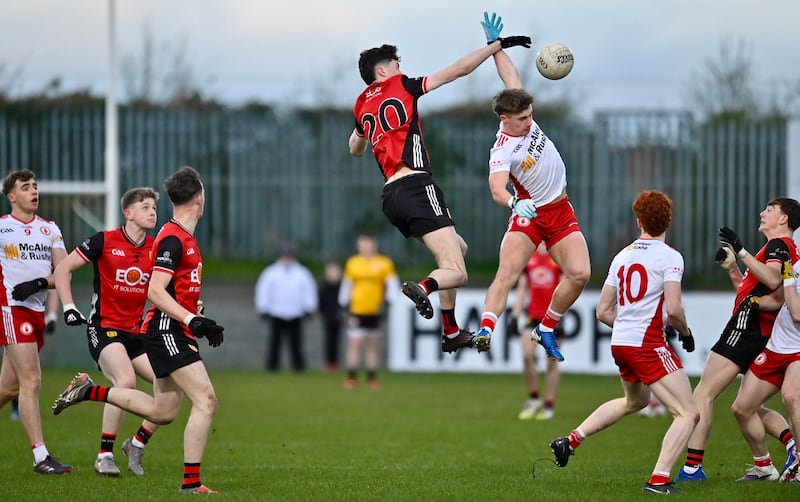 Down and Tyrone players jump for the ball