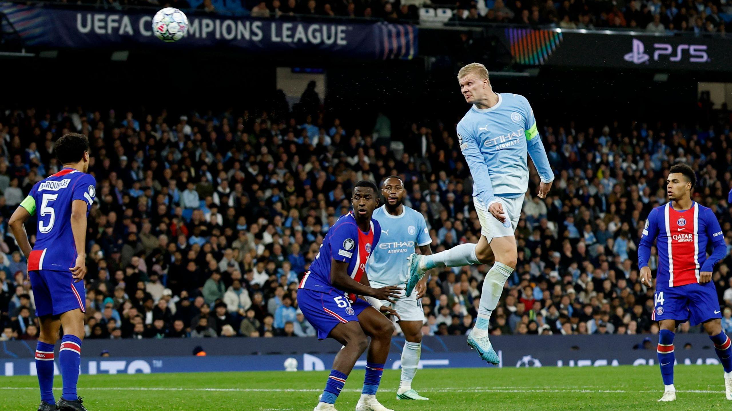 Erling Haaland leaps above the PSG defence to head home Manchester City's first goal. The French side won a thrilling game 4-2