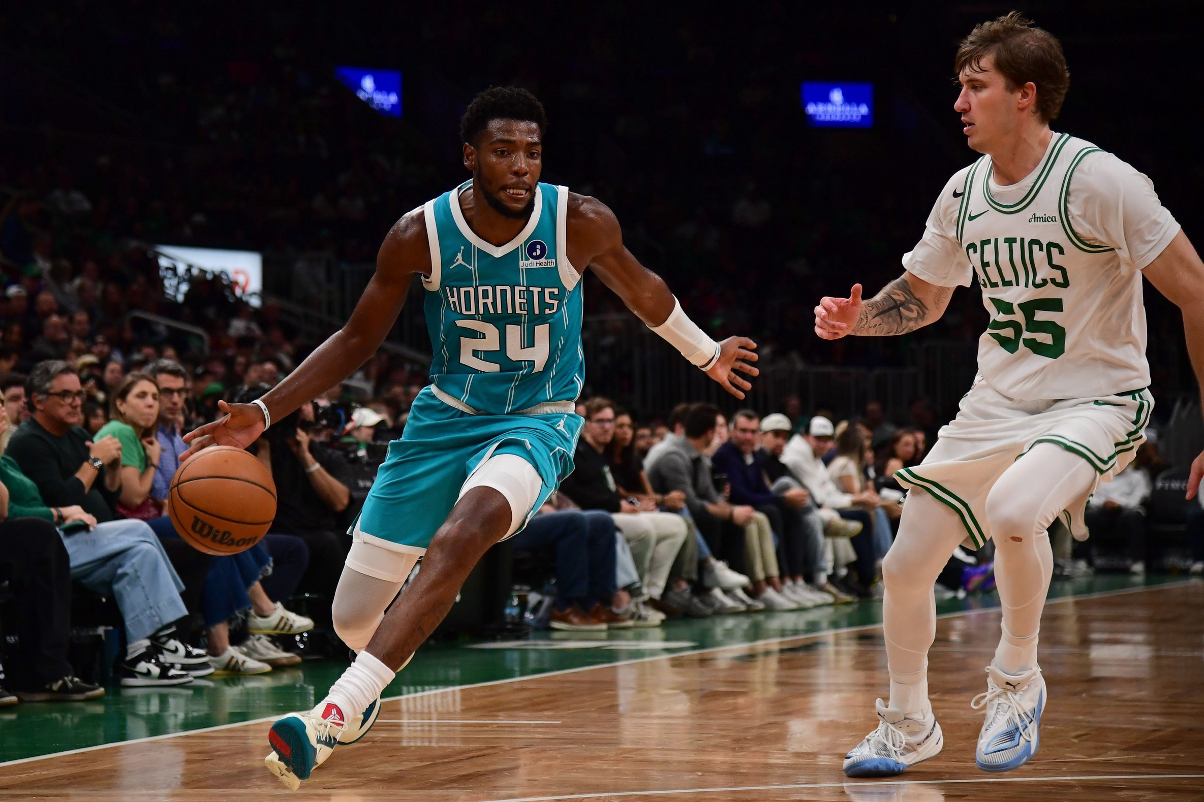 Oct 14, 2026; Boston, Massachusetts, USA;  Charlotte Hornets forward Brandon Miller (24) controls the ball while Boston Celtics guard Baylor Scheierman (55) defends during the second half at TD Garden. Mandatory Credit: Bob DeChiara-Imagn Images