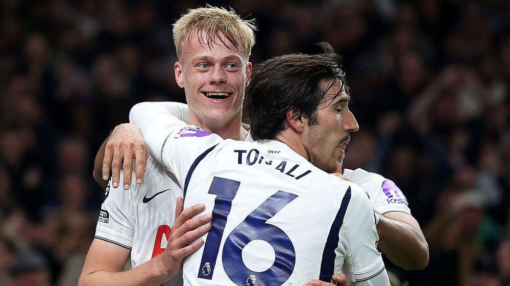 Tottenham's Sandro Tonali hugs smiling goalscorer Jan Paul van Hecke