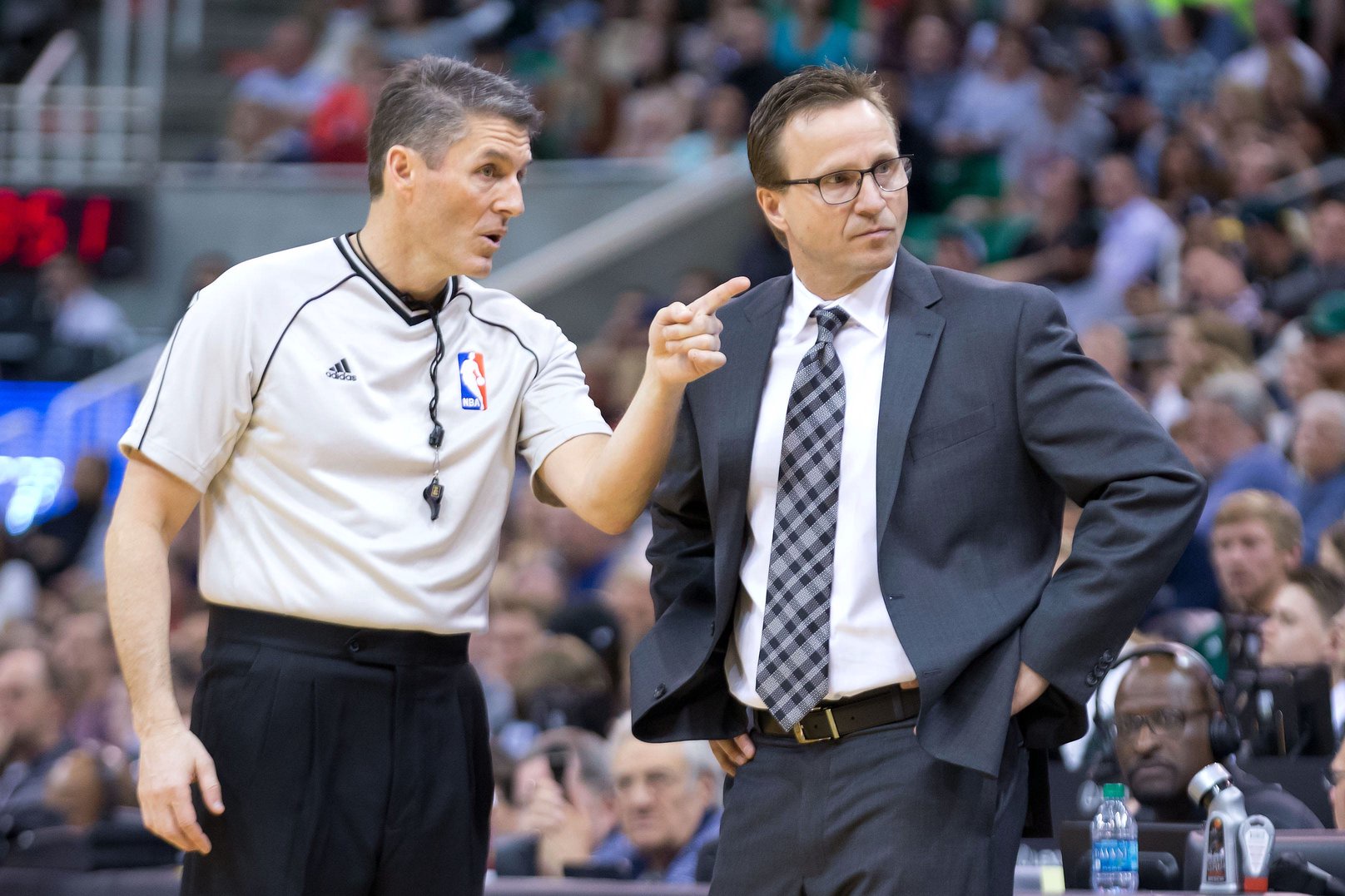 Mar 28, 2015; Salt Lake City, UT, USA; referee Scott Foster (48) talks with Oklahoma City Thunder head coach Scott Brooks during the second half against the Utah Jazz at EnergySolutions Arena. The Jazz won 94-89. Mandatory Credit: Russ Isabella-USA TODAY Sports
