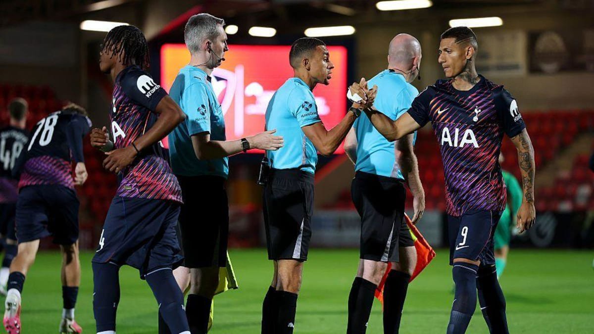 Richarlison shakes hands with referee Harrison Blair before an EFL Trophy game