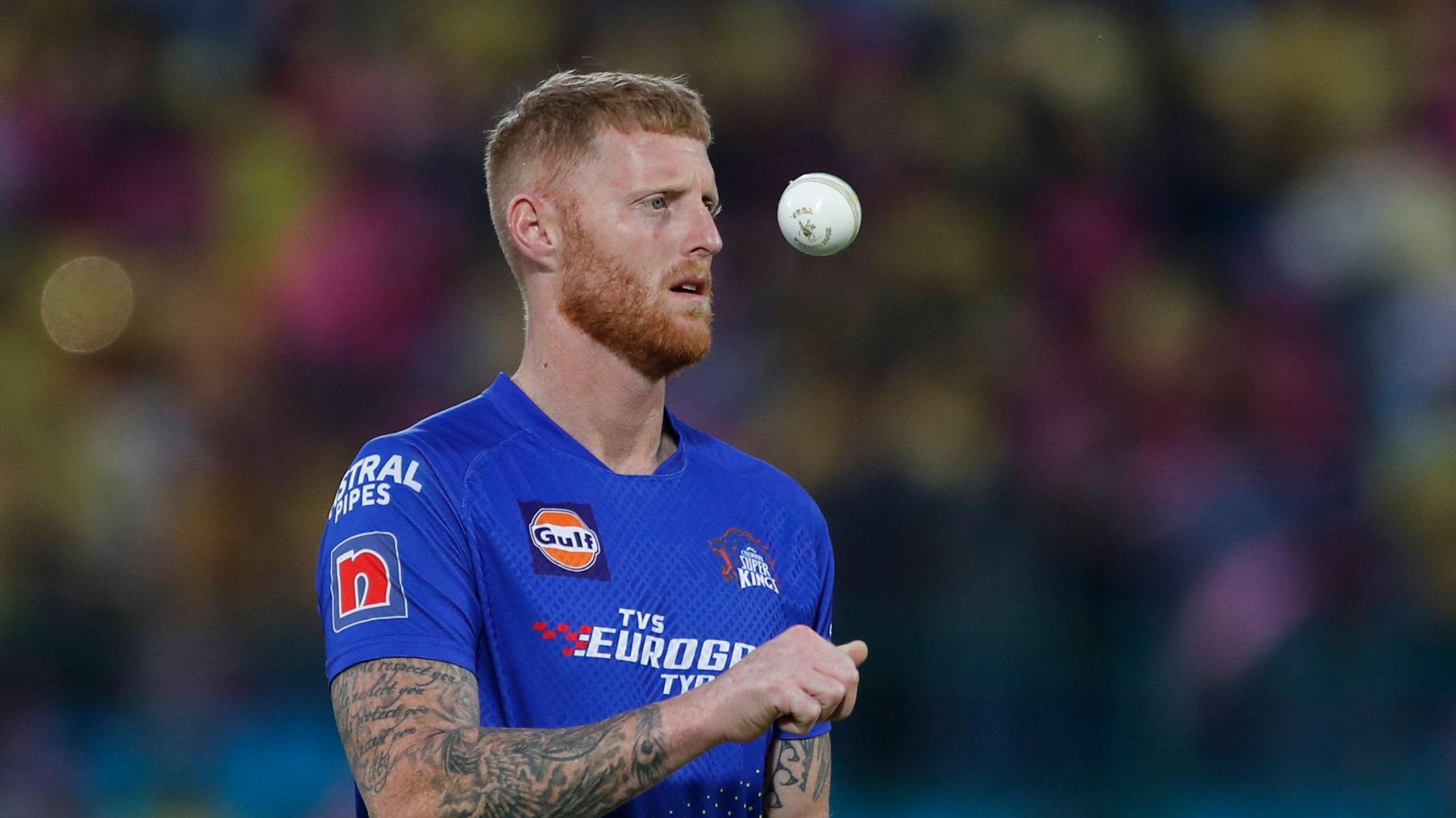 Ben Stokes throwing the white ball up as he prepares to start his bowling run-up for Chennai Super Kings