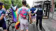 The Pride reveller is walked away in handcuffs by police officers in London