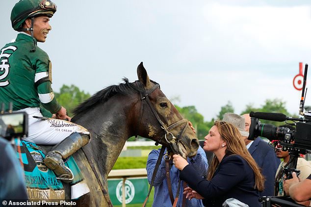 FILE - Trainer Cherie DeVaux, right, greets Golden Tempo (9) and Jockey Jose Ortiz after they won the 158th running of the Belmont Stakes horse race on June 6, 2026, in Saratoga Springs, N.Y. (AP Photo/Yuki Iwamura, File)