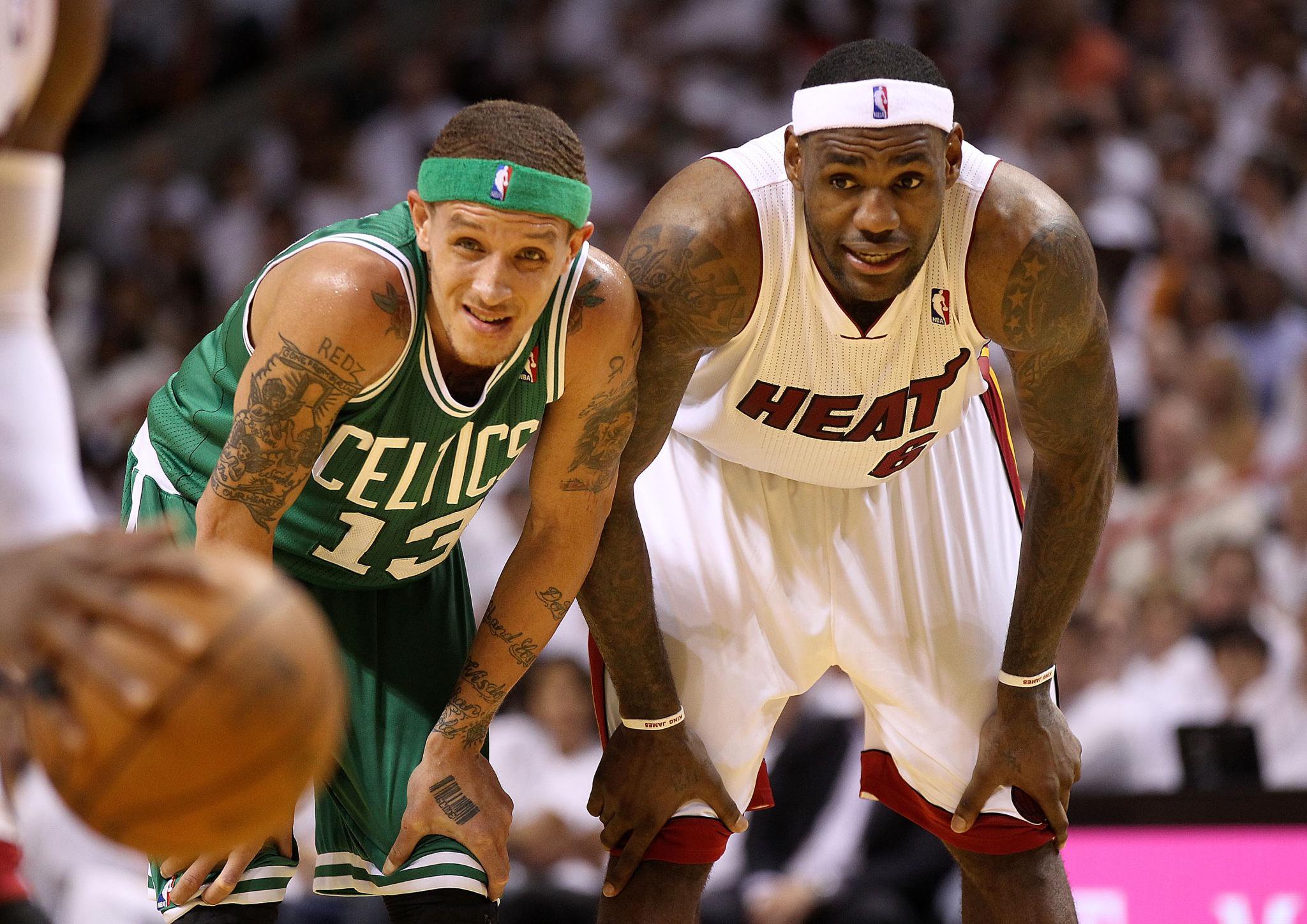 Delonte West of the Boston Celtics and LeBron James of the Miami Heat stand on the court during a game.