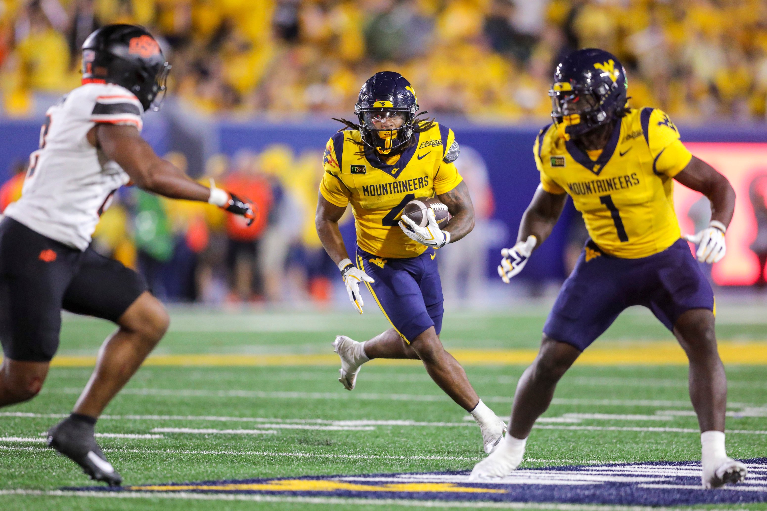 Sep 26, 2026; Morgantown, West Virginia, USA; West Virginia Mountaineers running back Cam Cook (4) runs the ball during the fourth quarter against the Oklahoma State Cowboys at Milan Puskar Stadium. Mandatory Credit: Ben Queen-Imagn Images