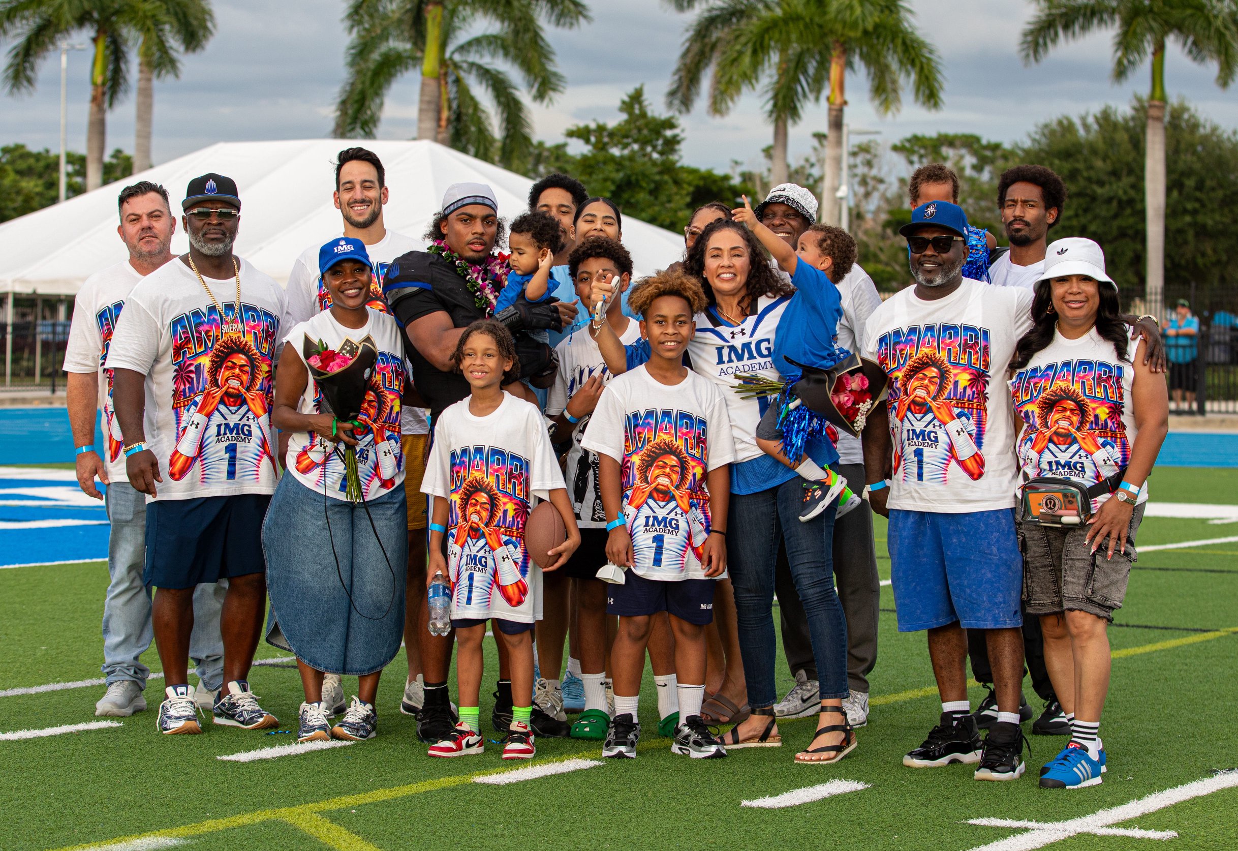 IMG Academy National beat The St. James Performance Academy 44-42 in Bradenton on Saturday, Oct. 3, 2026. Amarri Irvin poses with his family and friends while holding the youngest member of the group.