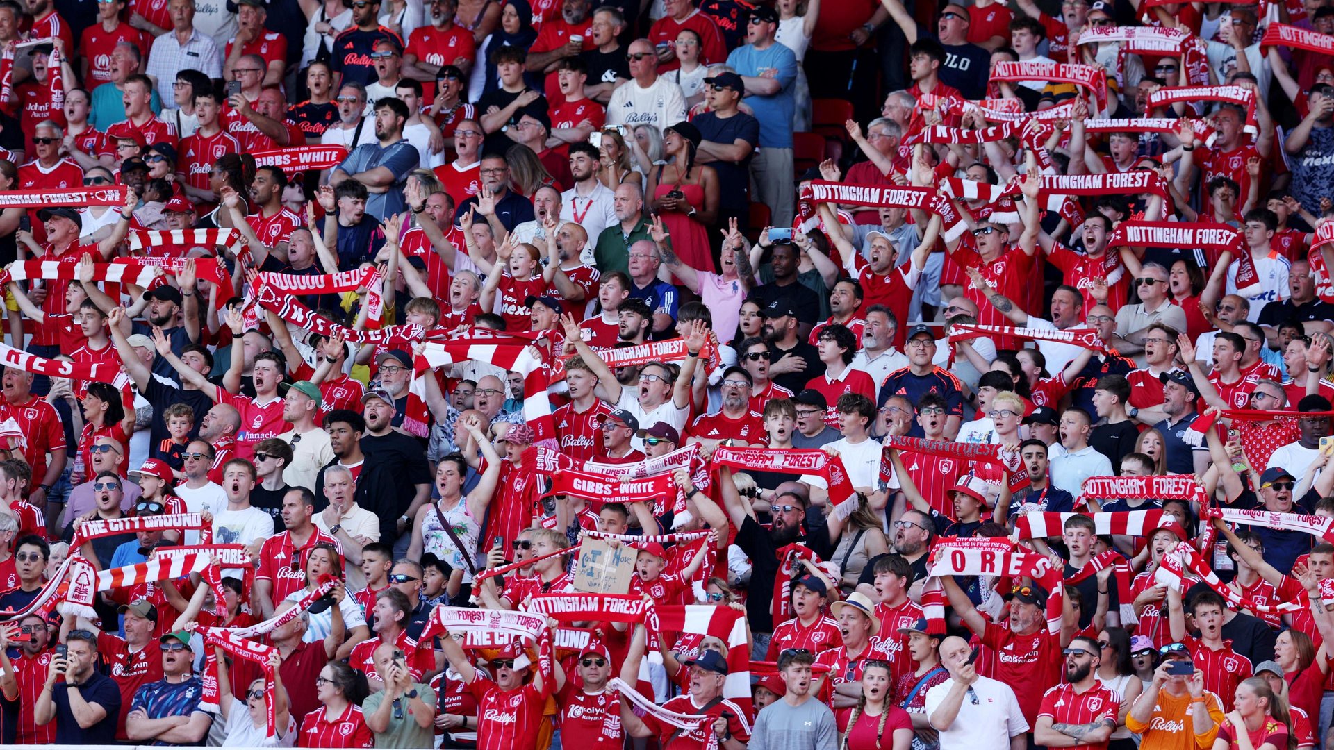 Pictures of Nottingham Forest supporters in the stands cheering and waving Forest scarves. 
