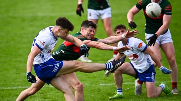 Bobby McCaul of Monaghan shoots under pressure from Conor Loftus of Mayo - 2026 All-Ireland Championship