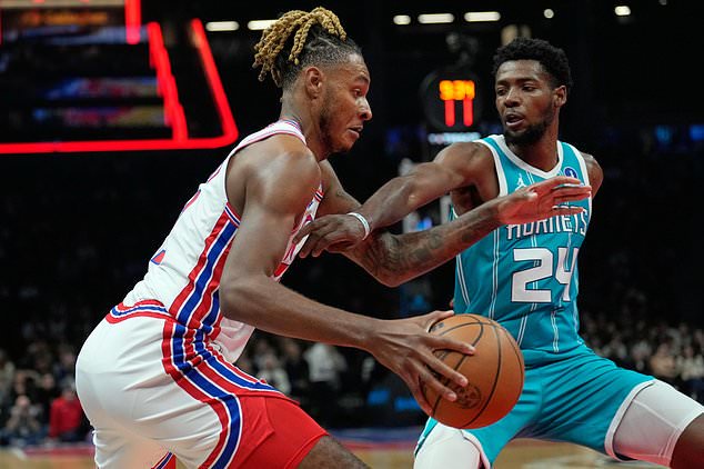 Charlotte Hornets' Brandon Miller, right, defends Brooklyn Nets' Noah Clowney during the first half of an NBA basketball game Wednesday, Oct. 21, 2026, in New York. (AP Photo/Seth Wenig)