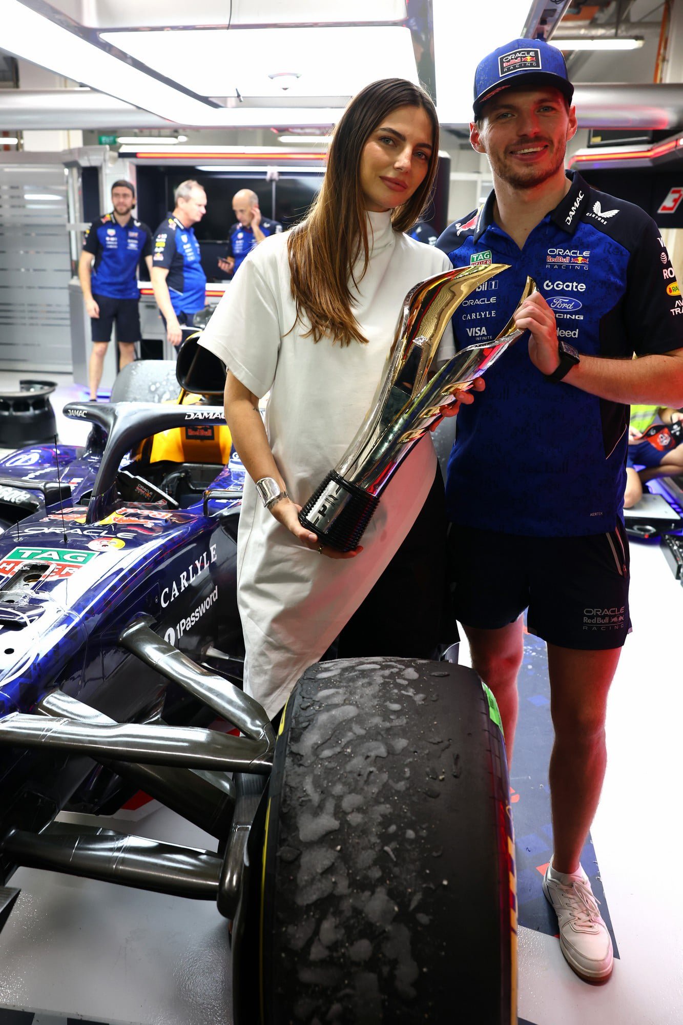 Max Verstappen and Kelly Piquet pose with his trophy in the Red Bull garage at the Singapore Grand Prix