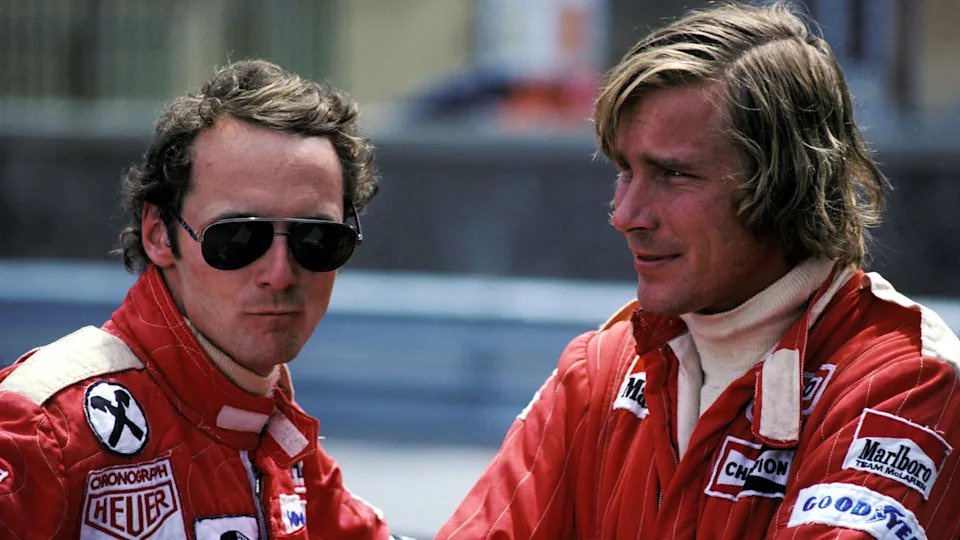 Ferrari's Niki Lauda, wearing sunglasses, and McLaren's James Hunt in conversation in 1976