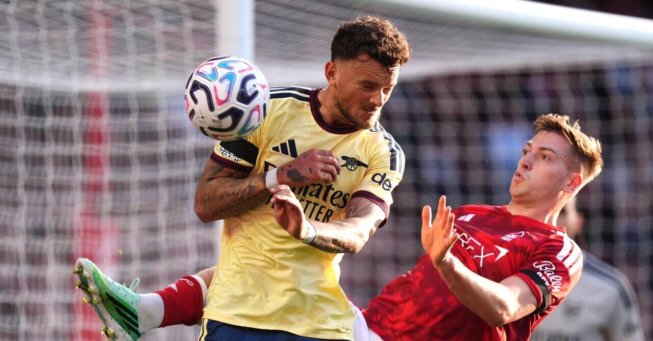 Arsenal's Ben White (left) and Nottingham Forest's Liam Delap battle for the ball during the Premier League match at the City Ground, Nottingham