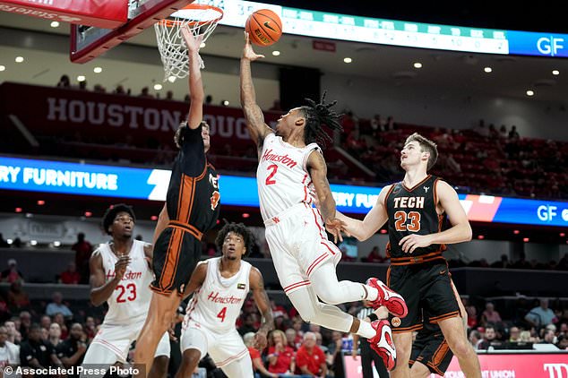 Houston guard Corey Hadnot (2) drives to the basket as Montana Tech forward Ethan Venema, left, defends during the second half of an NCAA college basketball exhibition game Thursday, Oct. 15, 2026, in Houston. (AP Photo/Eric Christian Smith)