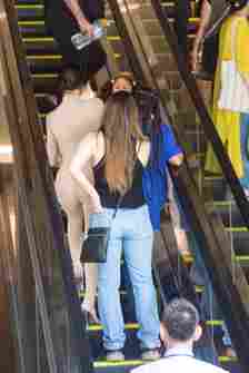 Bianca Censori and North West riding an escalator together