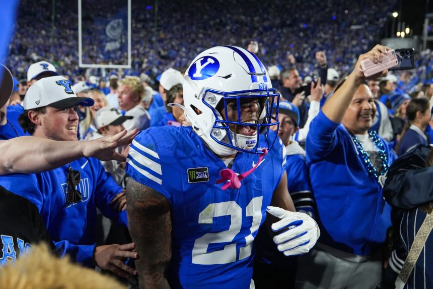 BYU fans storm the field after defeating the Notre Dame on Saturday.