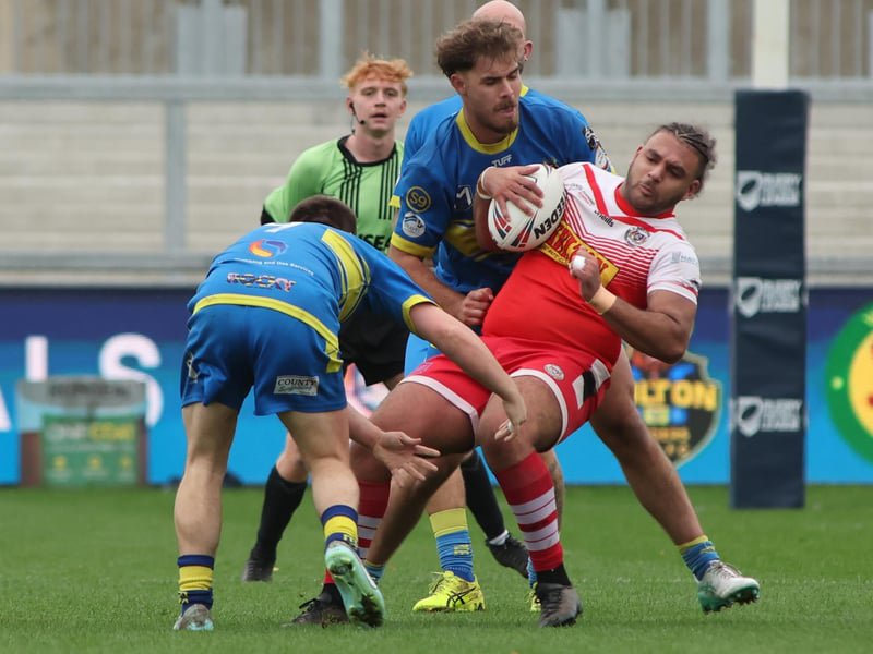 The Oulton Raiders defence gets to grips with East Leeds forward Isaac Coleman.
