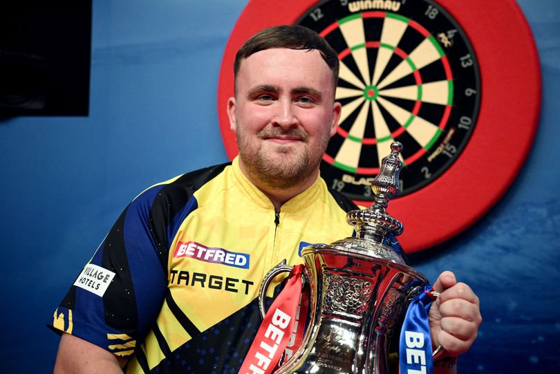 Luke Littler poses for a photo with the 2026 Betfred World Matchplay trophy