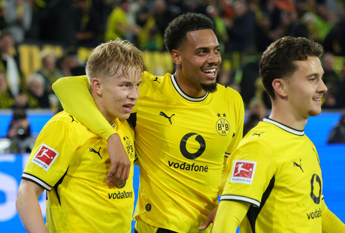 Daniel Svensson of Borussia Dortmund celebrates with teammates Felix Nmecha of Borussia Dortmund (C) and Konstantinos Karetsas of Borussia Dortmund after scoring his team's first goal during the Bundesliga 2026/27 match between Borussia Dortmund and SV Werder Bremen