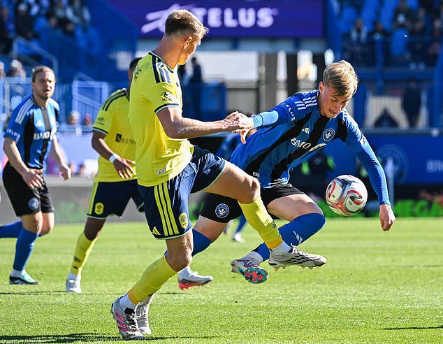 Nashville SC's Sam Surridge, left, and CF Montreal's Hennadii Synchuk battle for the ball during the first half of an MLS soccer game in Montreal, Saturday, Oct. 24, 2026. (Graham Hughes/The Canadian Press via AP)