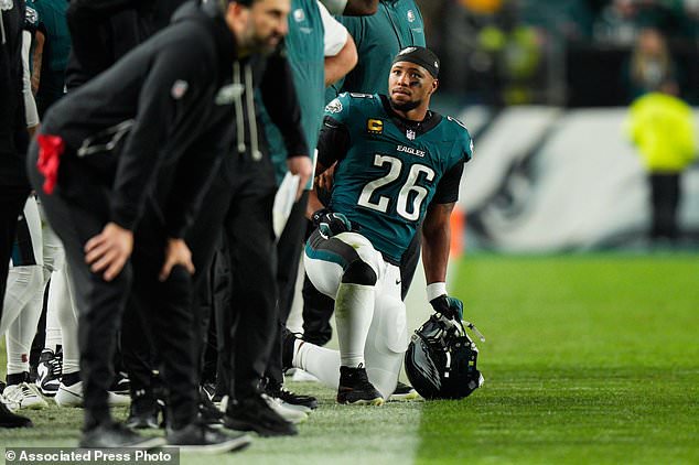 Philadelphia Eagles running back Saquon Barkley (26) kneels on the sidelines during the second half of an NFL football game against the Dallas Cowboys in Philadelphia, Monday, Oct. 26, 2026. (AP Photo/Chris Szagola)