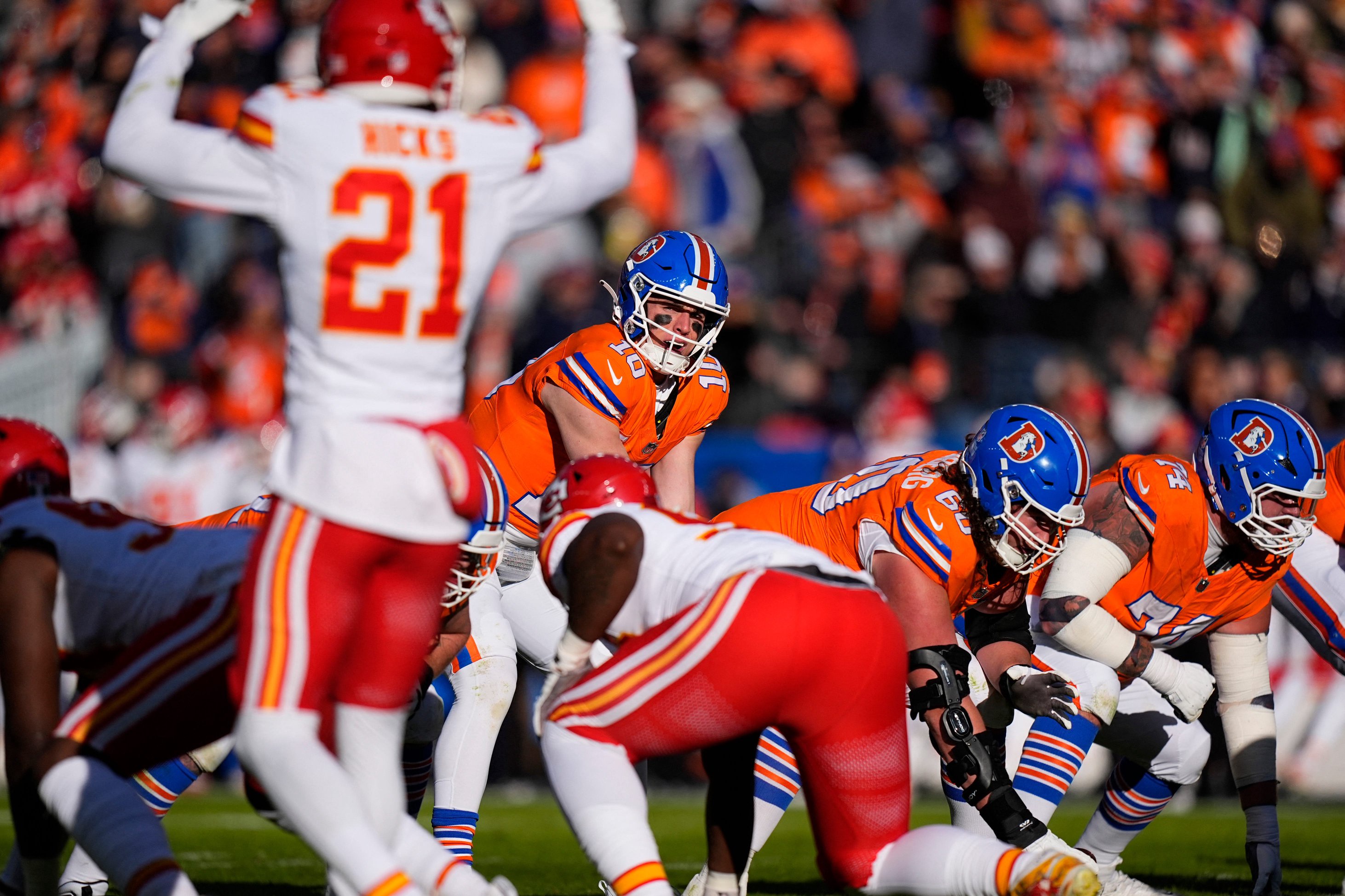 Jan 5, 2025; Denver, Colorado, USA; Denver Broncos quarterback Bo Nix (10) at the line of scrimmage during the first quarter against the Kansas City Chiefs at Empower Field at Mile High. Mandatory Credit: Ron Chenoy-Imagn Images