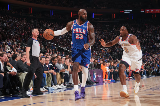 LeBron James #23 of the Philadelphia 76ers dribbles the ball during a basketball game.