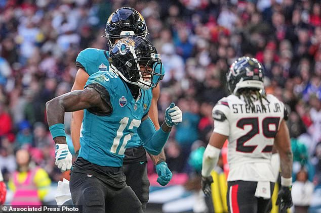 Jacksonville Jaguars wide receiver Travis Hunter (12) celebrates after scoring a touchdown during an NFL football game against Houston Texans in London, Sunday, Oct. 18, 2026. (AP Photo/Kin Cheung)