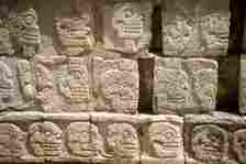 A close up view of ancient Mayan skull relief-carvings at Chichen Itza.