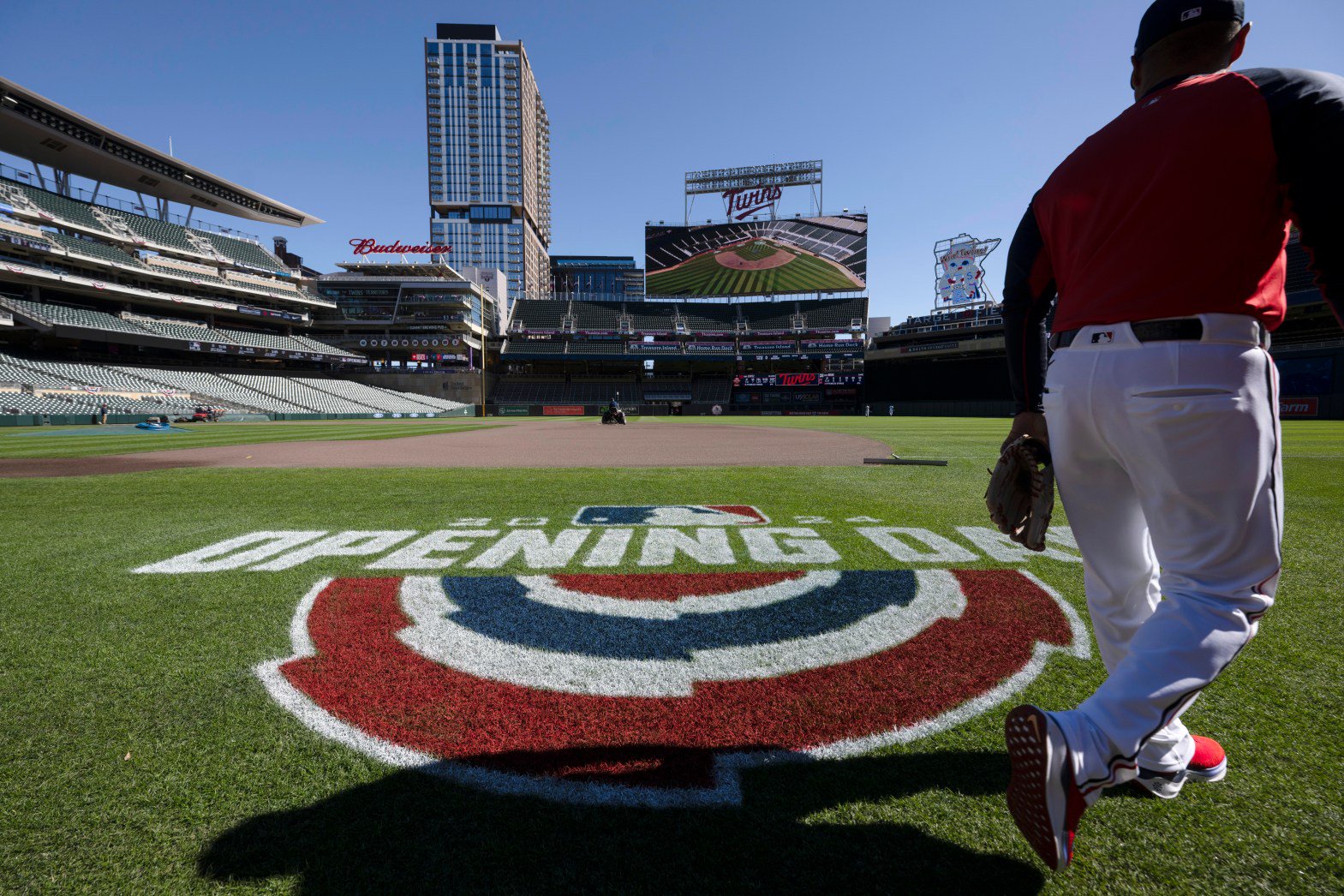 A coach walks onto the field at Target Field