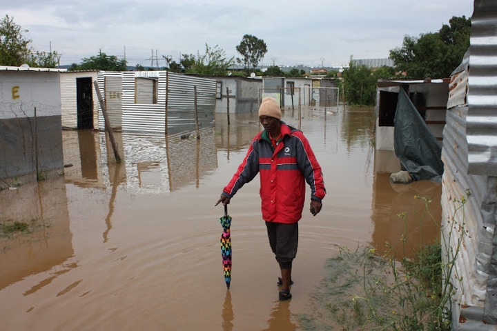 Resident of Eerstefabriek informal settlement in Mamelodi, Pretoria Solly Mogano walking in a flooded area after heavy rain swept away some of their shacks.