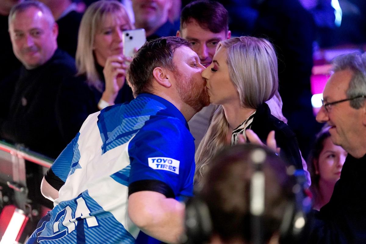 Fallon Sherrock and Cameron Menzies (left) embrace on day one of the Paddy Power World Darts Championship at Alexandra Palace, London. Picture date: Friday December 15, 2023.