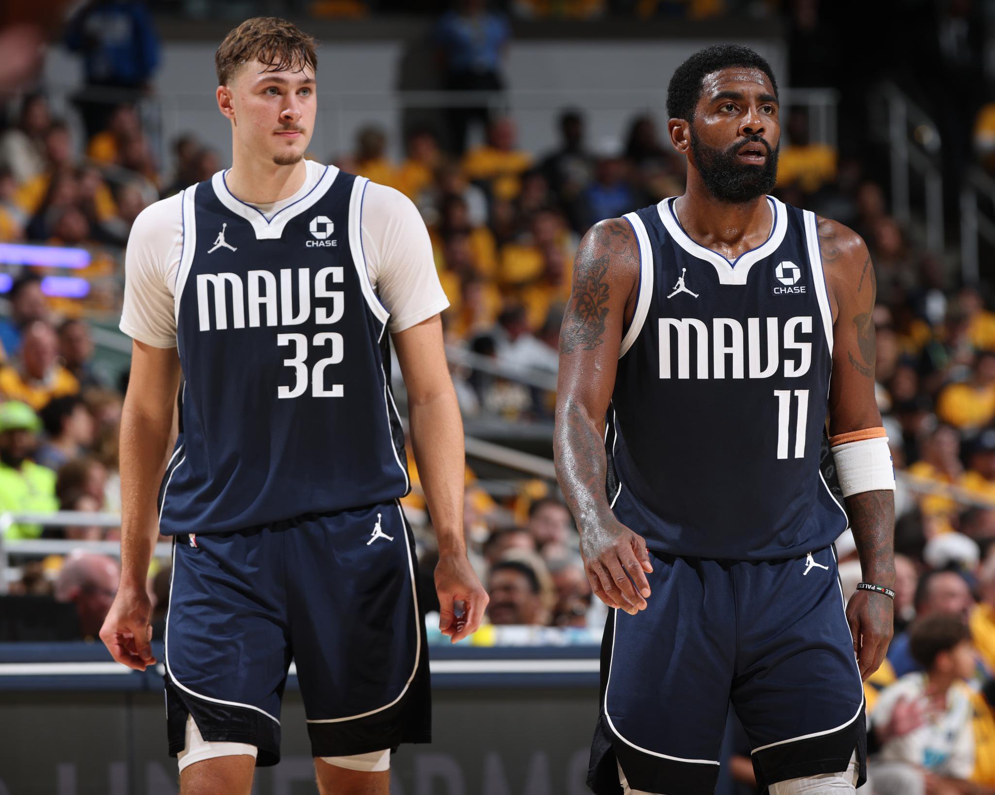 Cooper Flagg (32) and Kyrie Irving (11) of the Dallas Mavericks look on during a game against the Indiana Pacers.