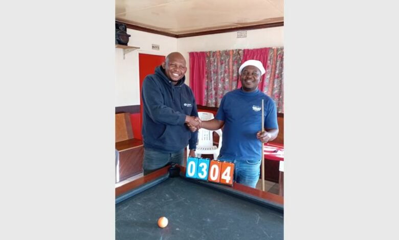 two men at a pool table