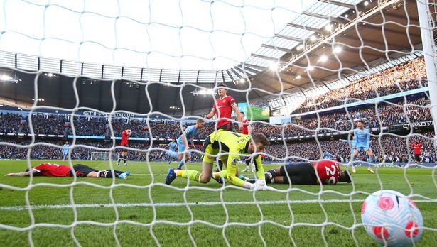 David de Gea of Manchester United looks dejected as Kevin De Bruyne of Manchester City celebrates scoring their second goal during the Premier League match between Manchester City and Manchester United at Etihad Stadium on March 06, 2022 in Manchester, England.
